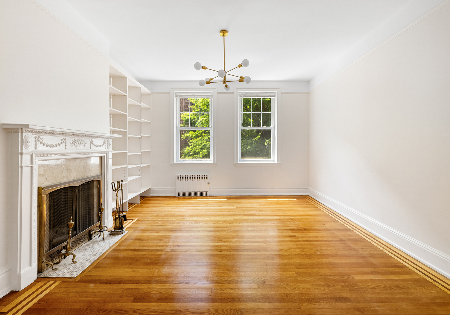 35-27 76th Street, Unit 21 Queens, NY 11372 - Photo 2 of 24 a view of an empty room with window and fireplace