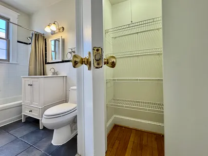 a bathroom with a toilet and a shower