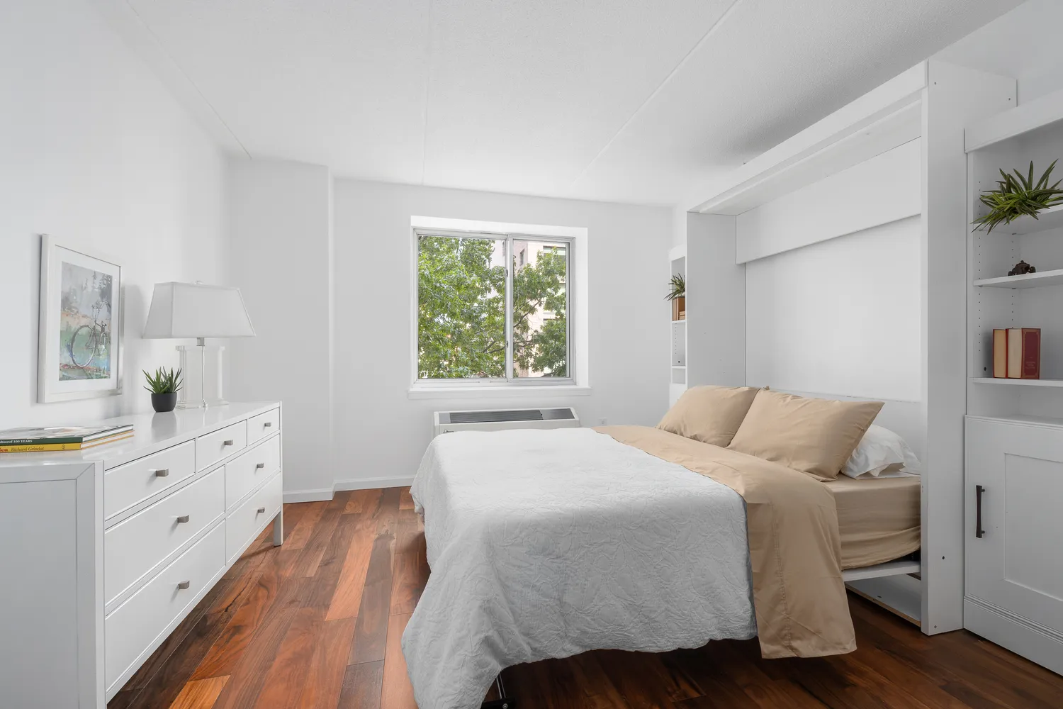 a bedroom with a bed and a dresser