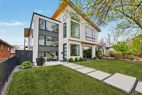 front view of a brick house with a yard