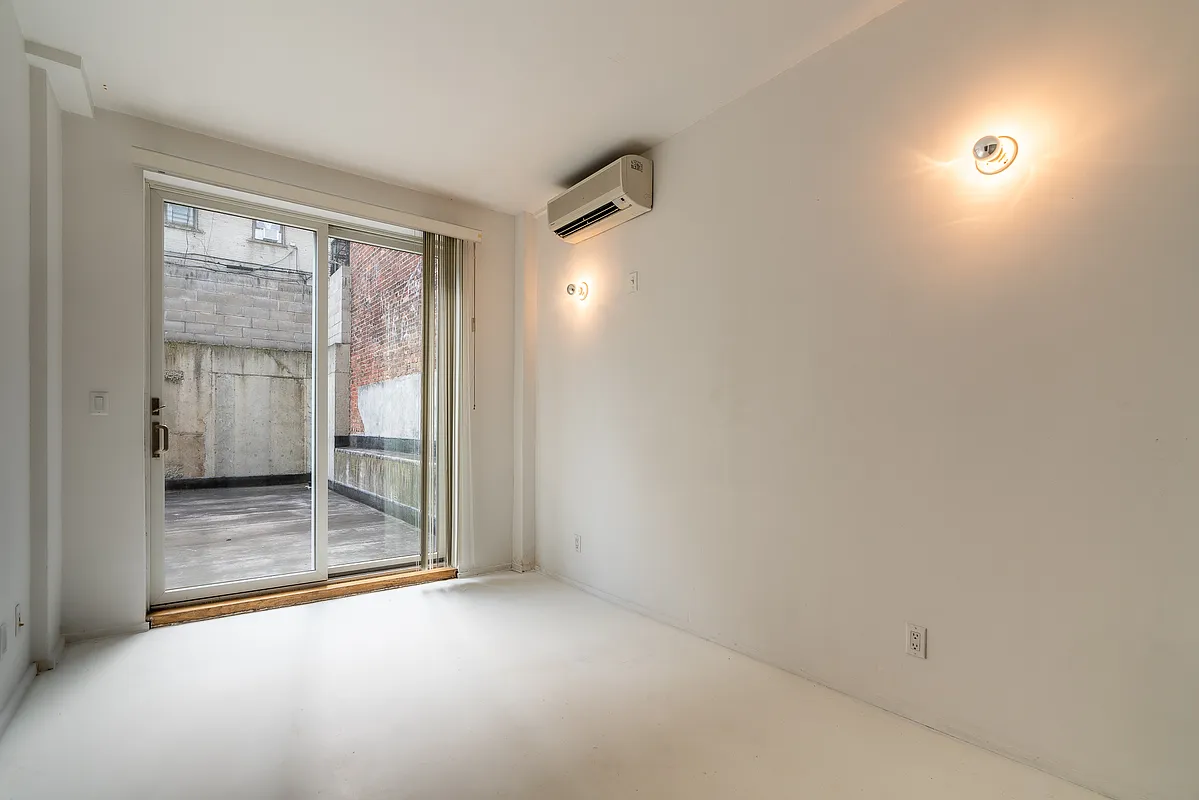 542 Saint Marks Avenue, Unit 101 Brooklyn, NY 11238 - Photo 4 of 5 an empty room with glass door