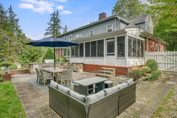 a view of a house with backyard sitting area and tub