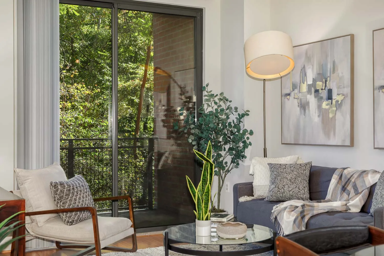 a living room with furniture and a potted plant