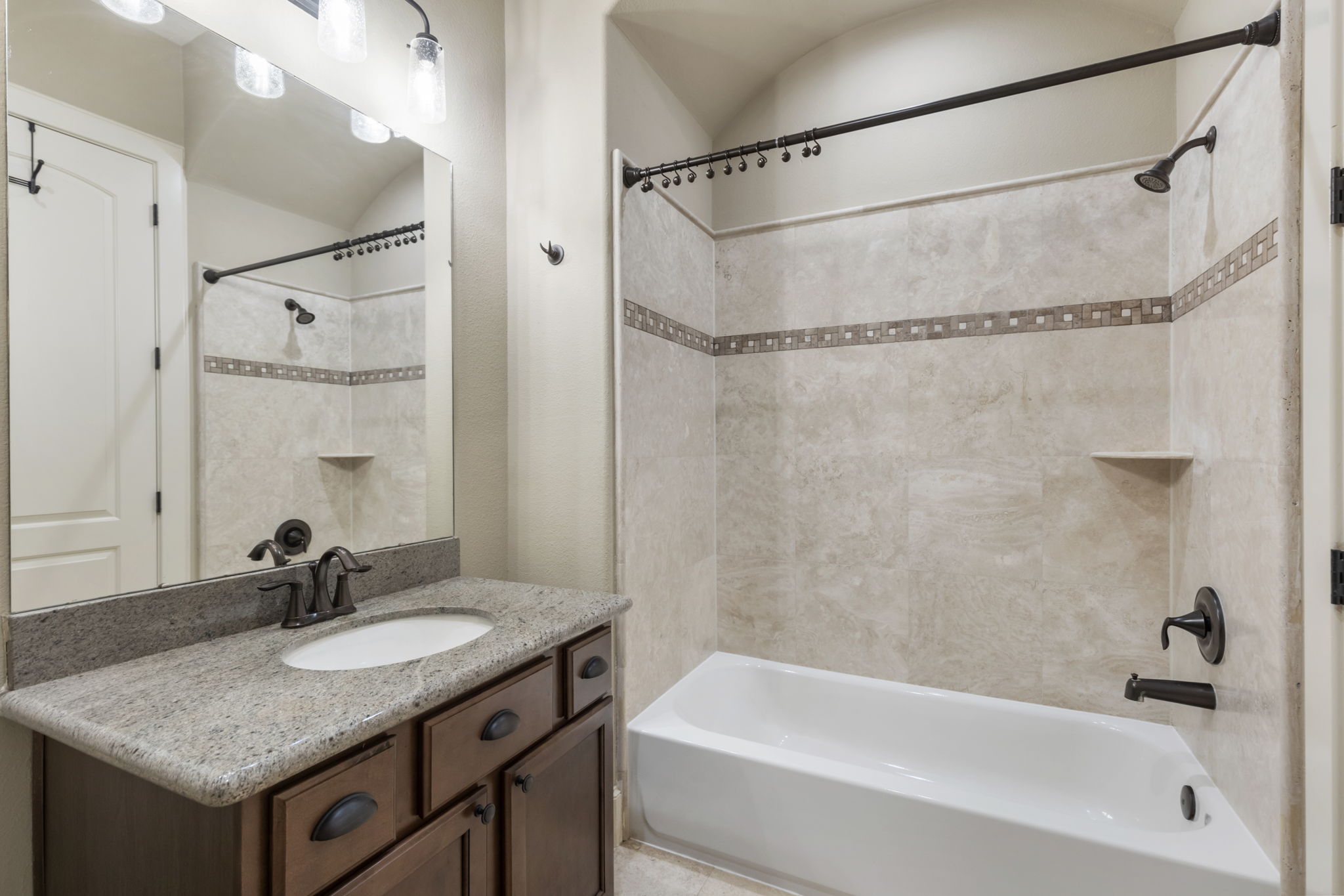5407 Feagan Street Houston, TX 77007 - Photo 33 of 43 a bathroom with a granite countertop shower sink vanity and a mirror
