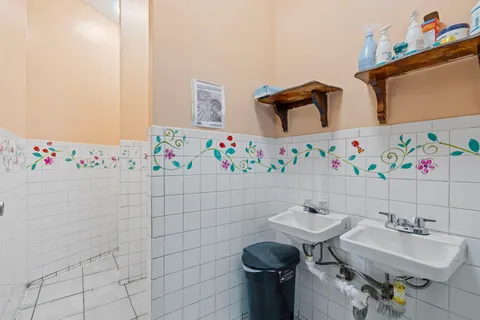 a bathroom with a sink mirror and toilet