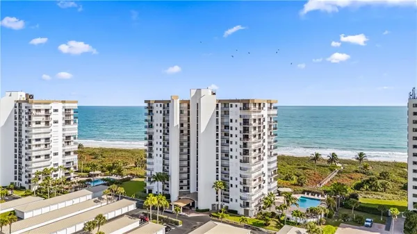 a view of ocean with a multi story building
