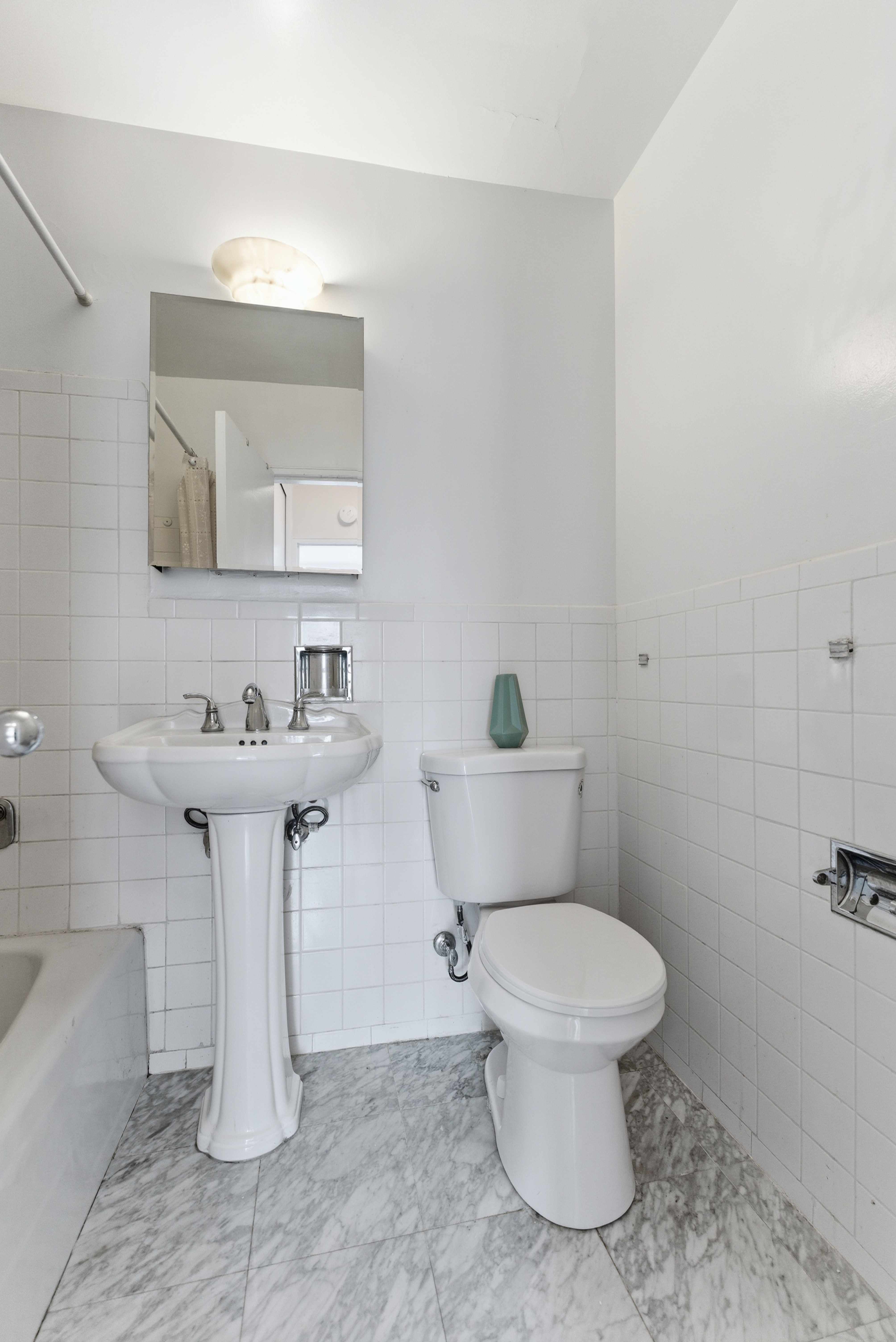 140 West End Avenue, Unit 6D Manhattan, NY 10023 - Photo 11 of 19 a bathroom with a sink toilet and a mirror