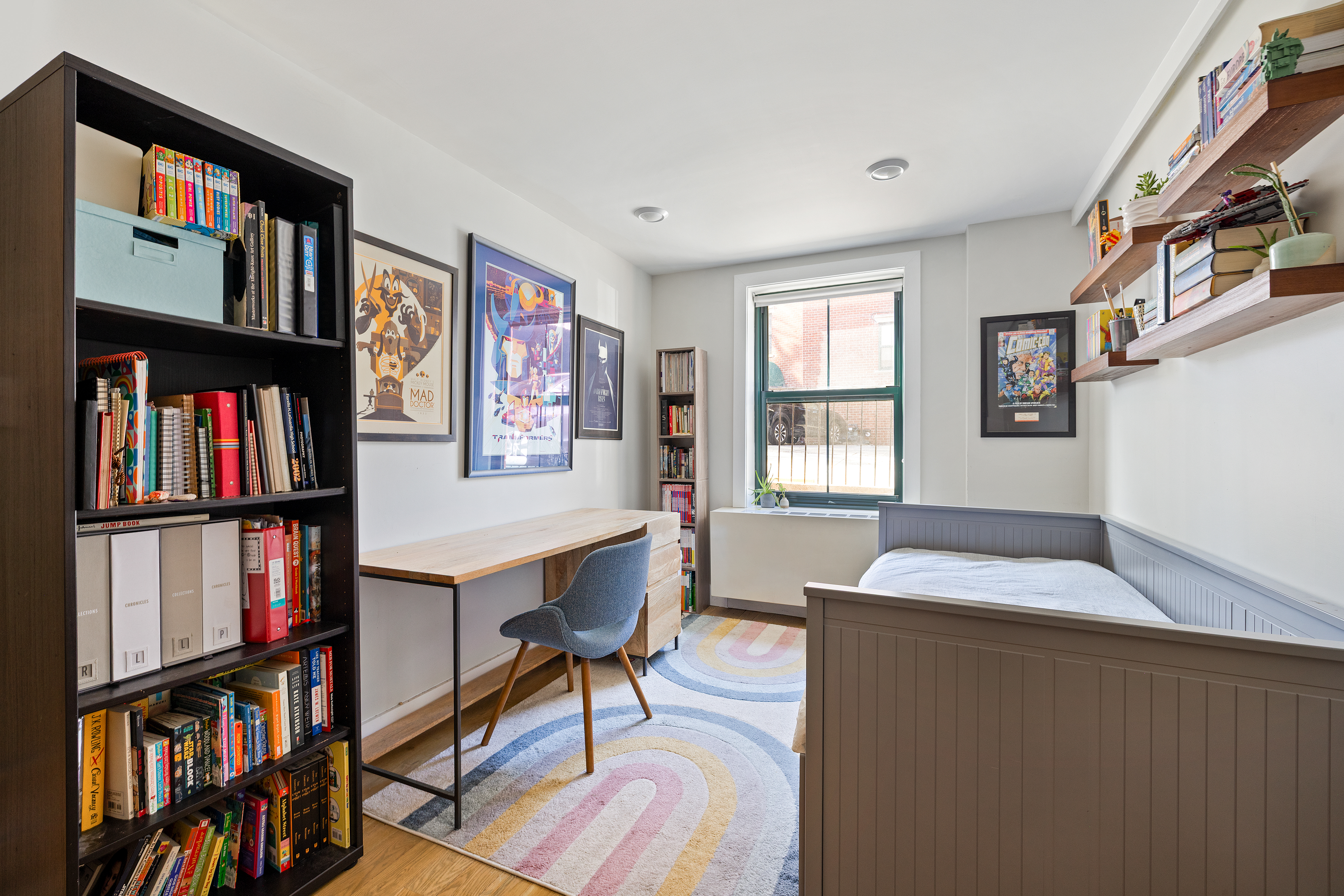 1115-1139 Prospect Avenue, Unit 1B Brooklyn, NY 11218 - Photo 3 of 9 a bedroom with a bed and a book shelf