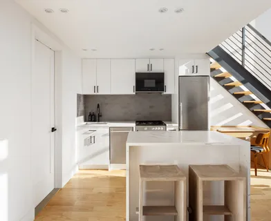a kitchen with stainless steel appliances a stove top oven a sink a microwave and refrigerator
