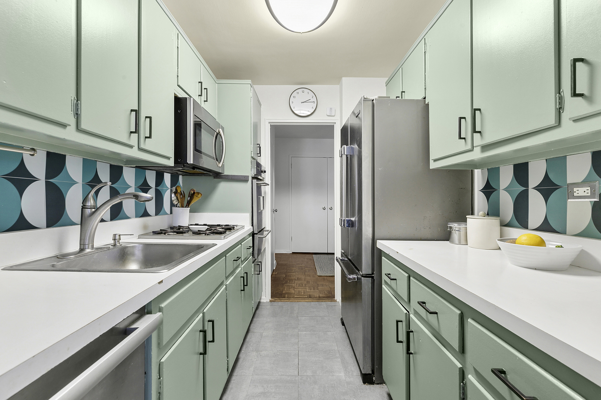 1199 Park Avenue, Unit 2F Manhattan, NY 10128 - Photo 5 of 12 a kitchen with stainless steel appliances granite countertop a sink and a refrigerator