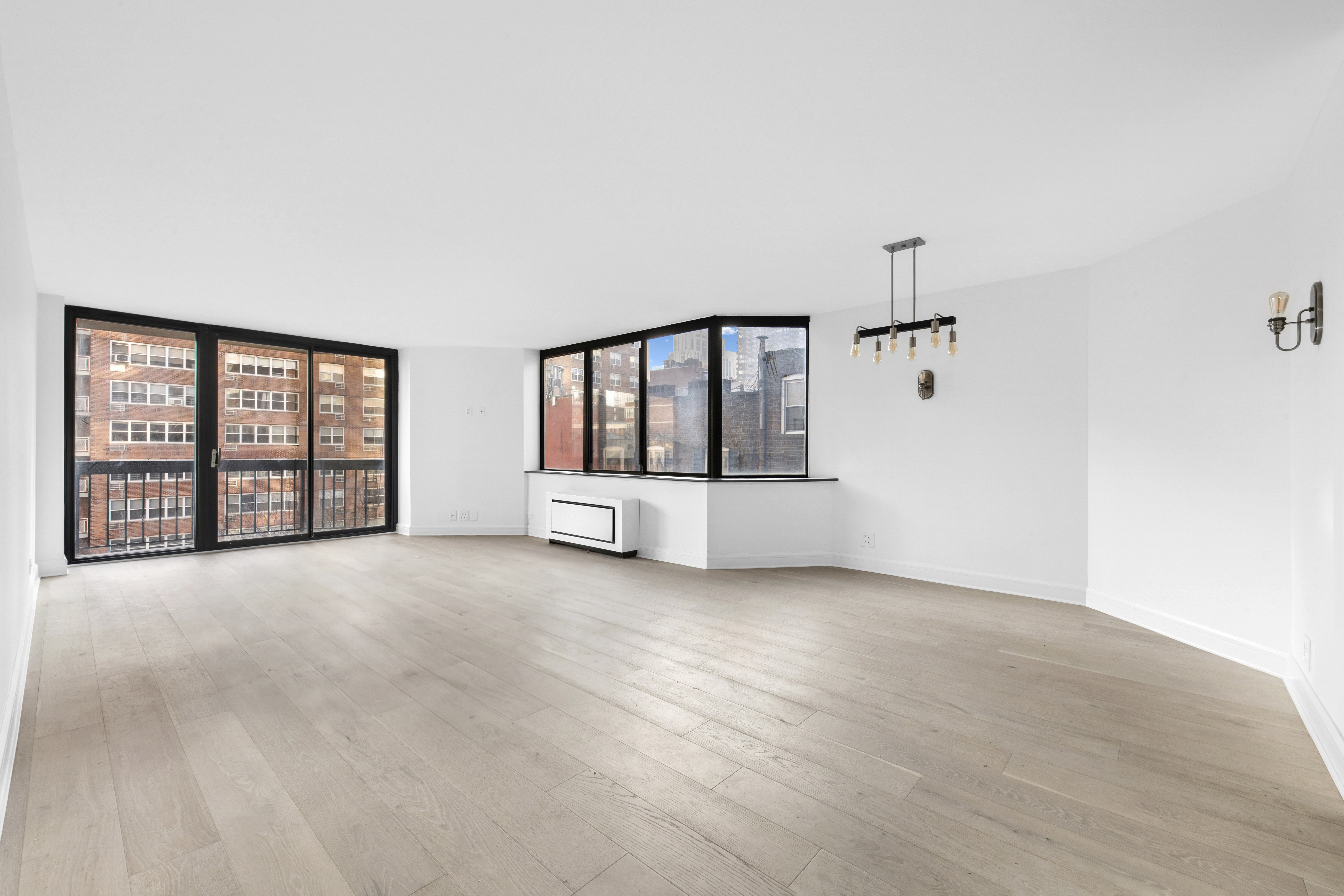 an empty room with windows and cabinet
