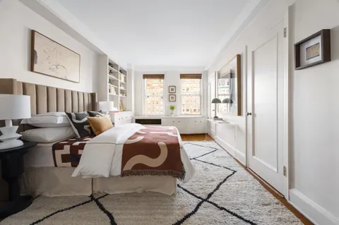 a bedroom with furniture and a window