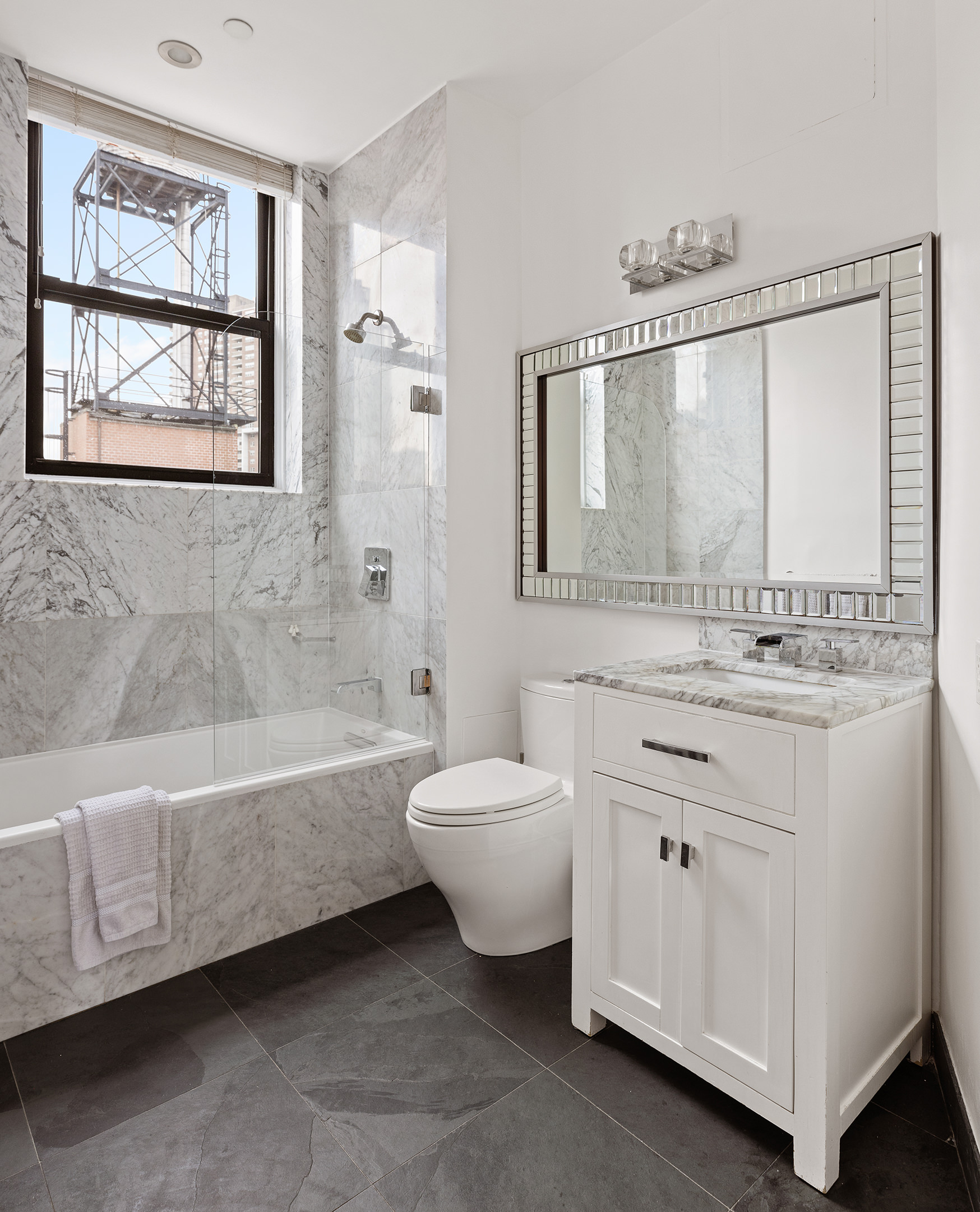 1 Hudson Street, Unit 9 Manhattan, NY 10013 - Photo 11 of 13 a bathroom with a sink a toilet and bathtub