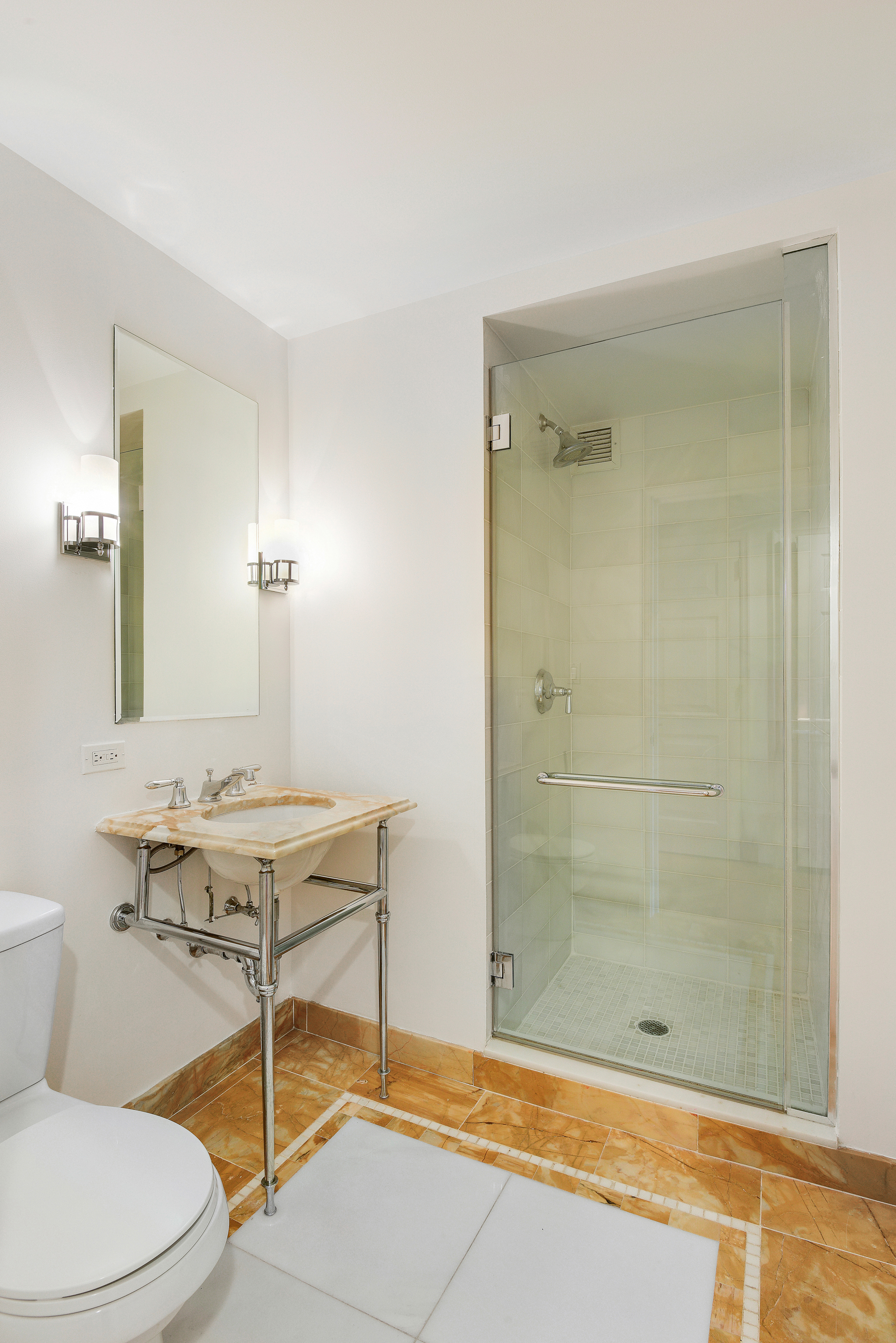 205 East 85th Street, Unit 12H Manhattan, NY 10028 - Photo 11 of 19 a bathroom with a sink a toilet and shower