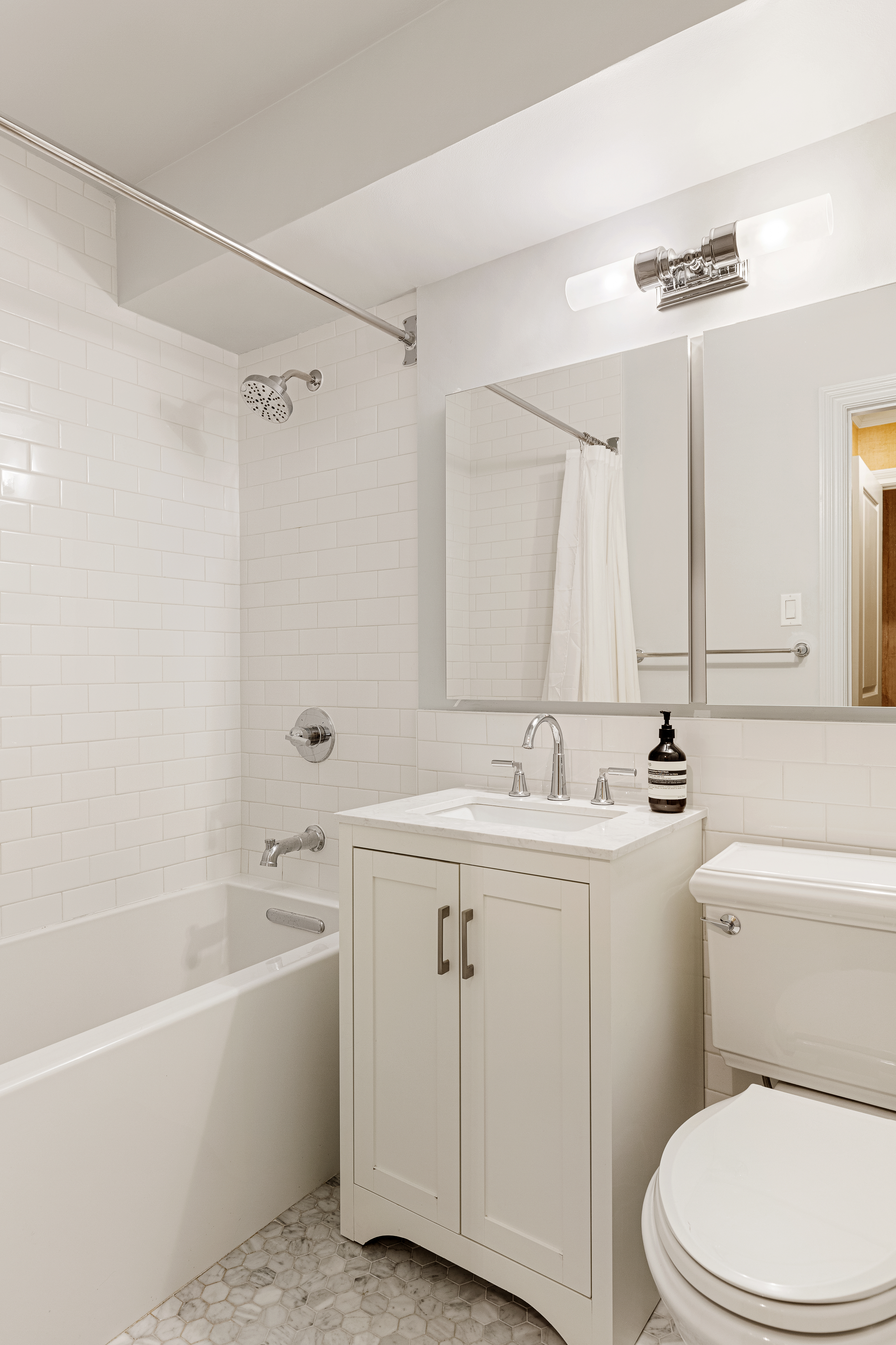 174 East 74th Street, Unit 3A Manhattan, NY 10021 - Photo 9 of 11 a bathroom with a sink a toilet and a bathtub