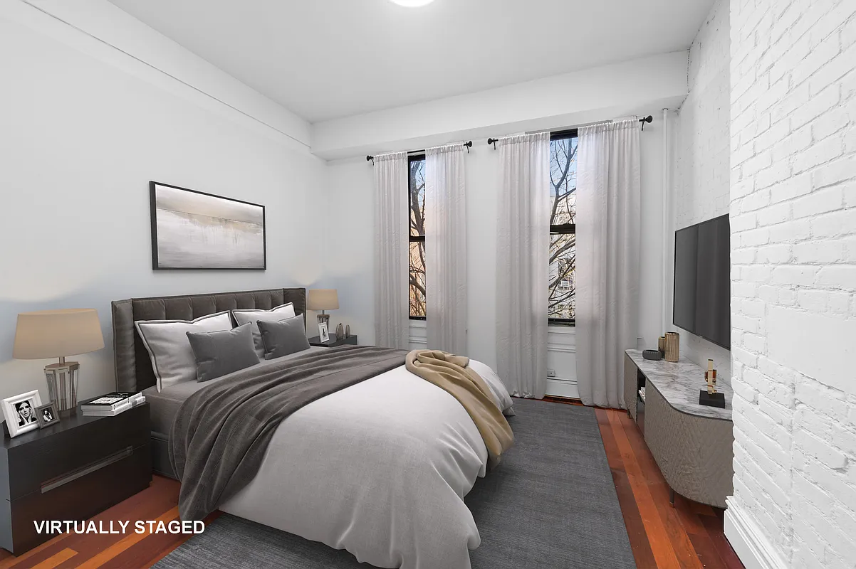 112 East 4th Street, Unit 6 Manhattan, NY 10003 - Photo 3 of 5 a bedroom with a bed and a flat screen tv