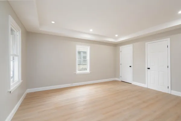 a view of empty room with wooden floor