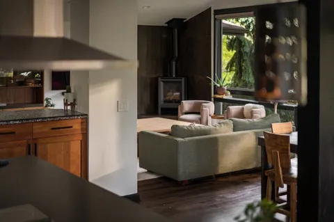 a living room with furniture potted plant and a flat screen tv