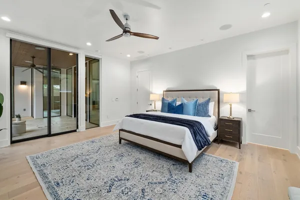 a bathroom with a granite countertop sink a bathtub a mirror and vanity