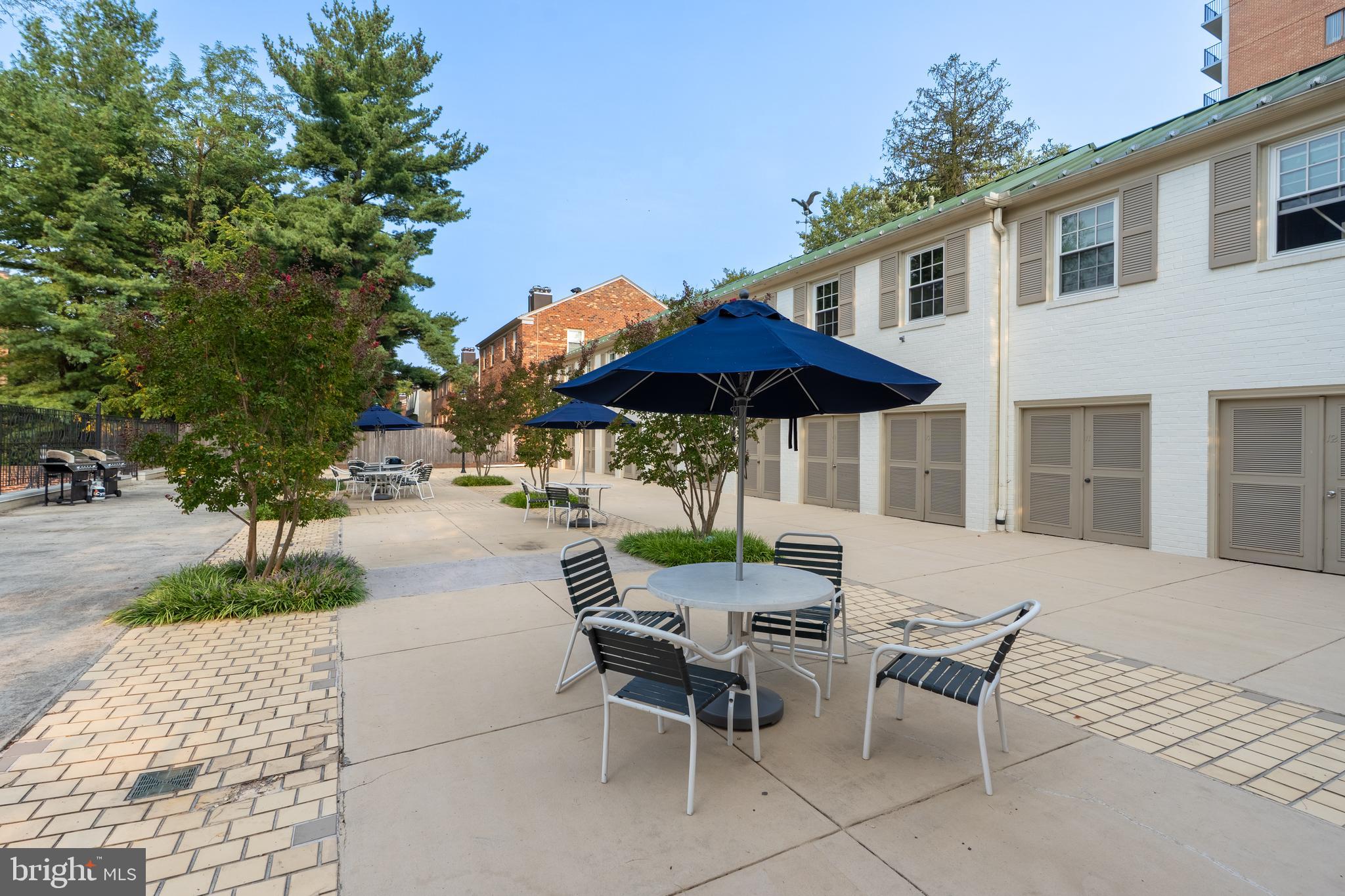 3299 Sutton Place Northwest, Unit C Washington, DC 20016 - Photo 35 of 41 an outdoor space with patio and white umbrellas