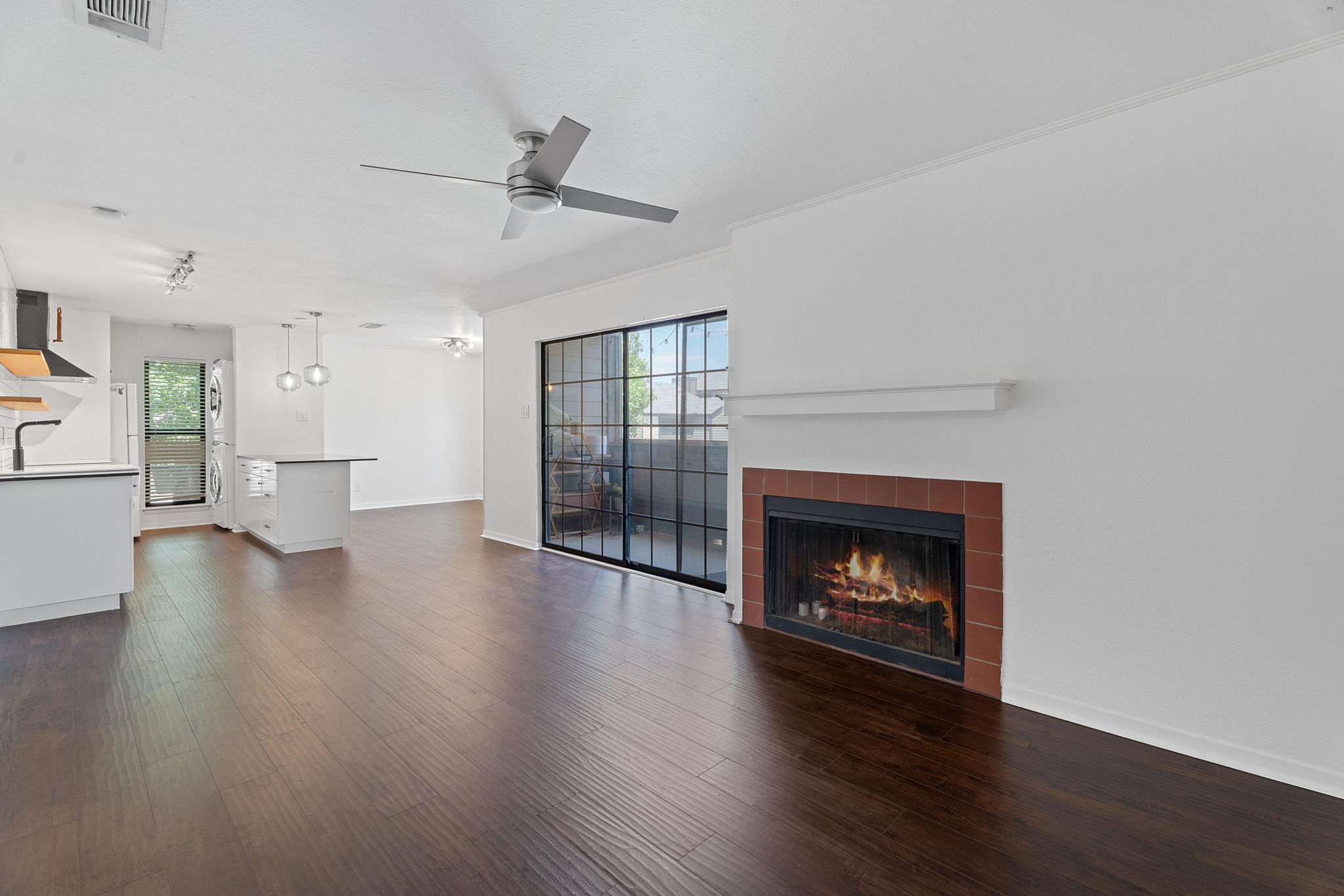1510 West N Loop Boulevard, Unit 424 Austin, TX 78756 - Photo 10 of 25 a view of an empty room with wooden floor fireplace and a window