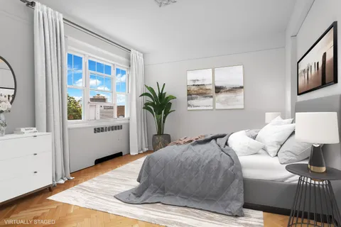 a bedroom with a large bed and a window