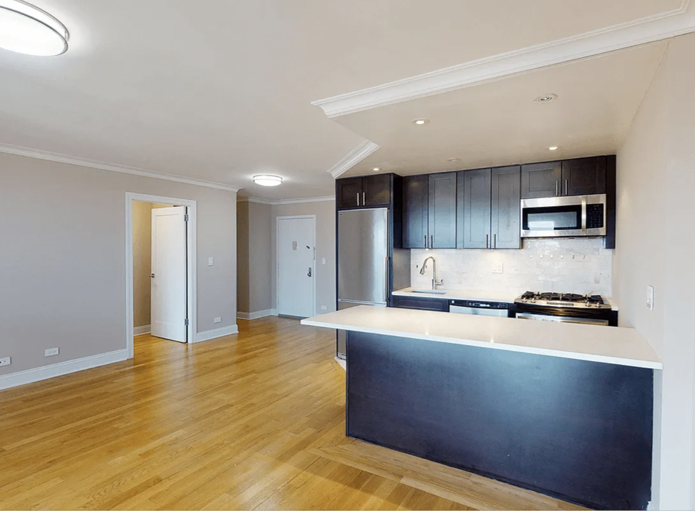 40 Harrison Street, Unit 24H Manhattan, NY 10013 - Photo 10 of 17 a kitchen with stainless steel appliances granite countertop a stove a sink and a refrigerator