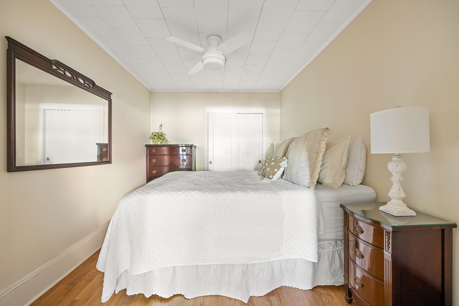 273 Windsor Place Brooklyn, NY 11218 - Photo 12 of 29 a bedroom with a bed and a lamp on dresser
