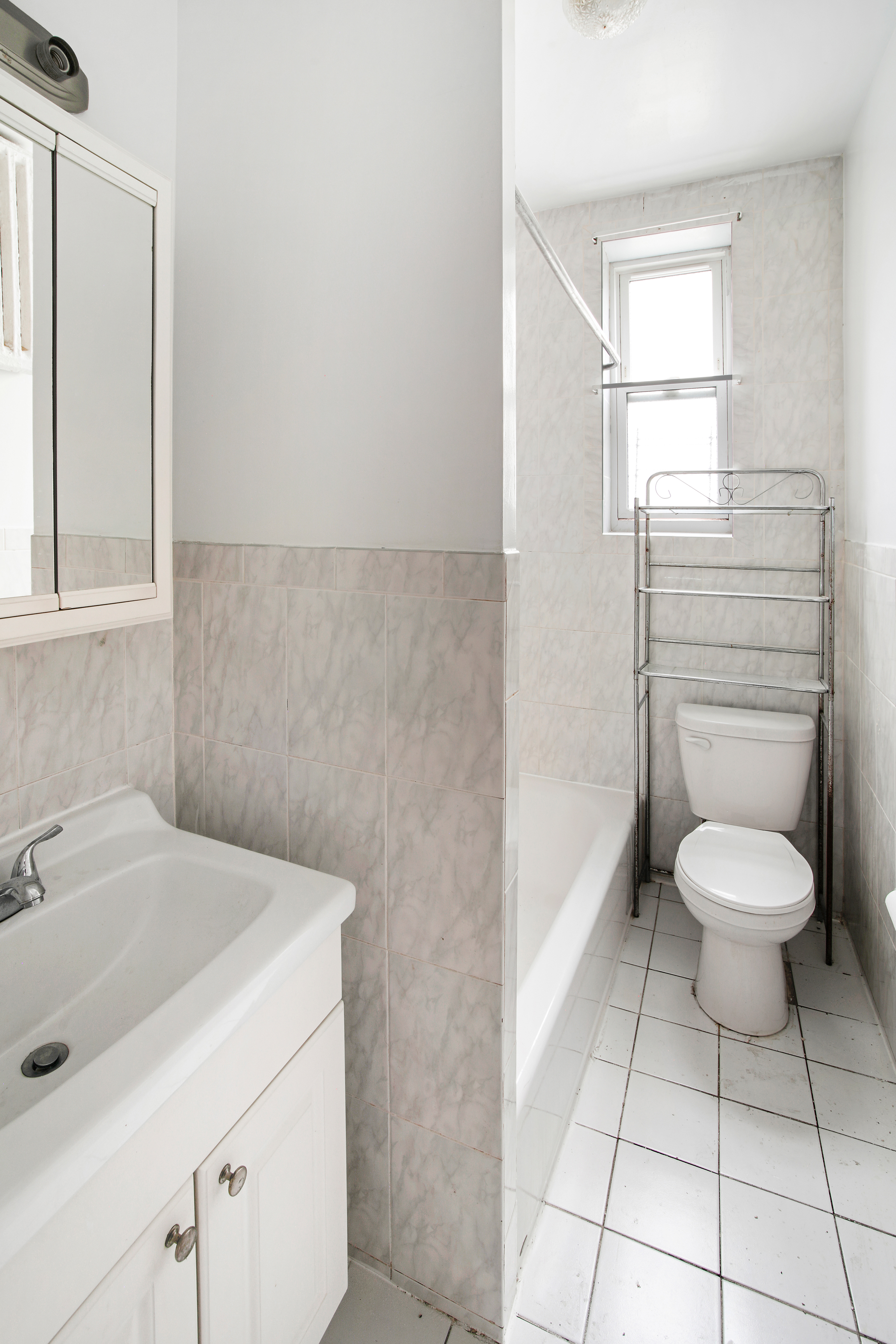 361 East 54th Street, Unit 2R Brooklyn, NY 11203 - Photo 9 of 9 a bathroom with a toilet sink and mirror