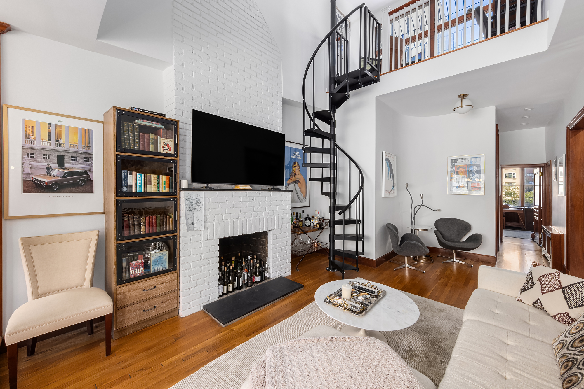 159 West 13th Street Manhattan, NY 10011 - Photo 32 of 36 a living room with fireplace furniture and a flat screen tv