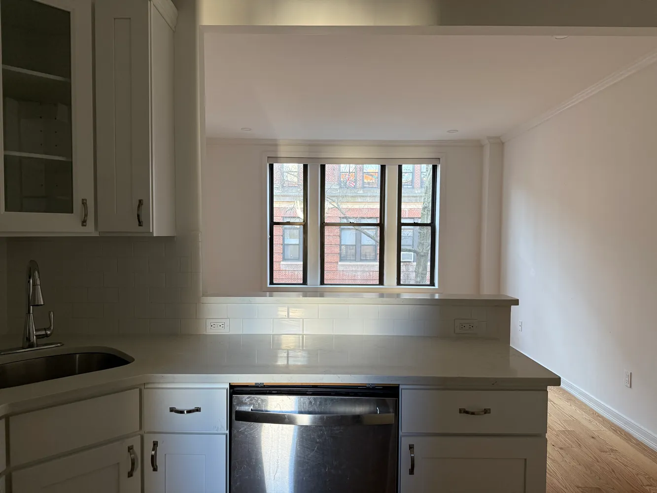 a kitchen with granite countertop cabinets stainless steel appliances and a sink