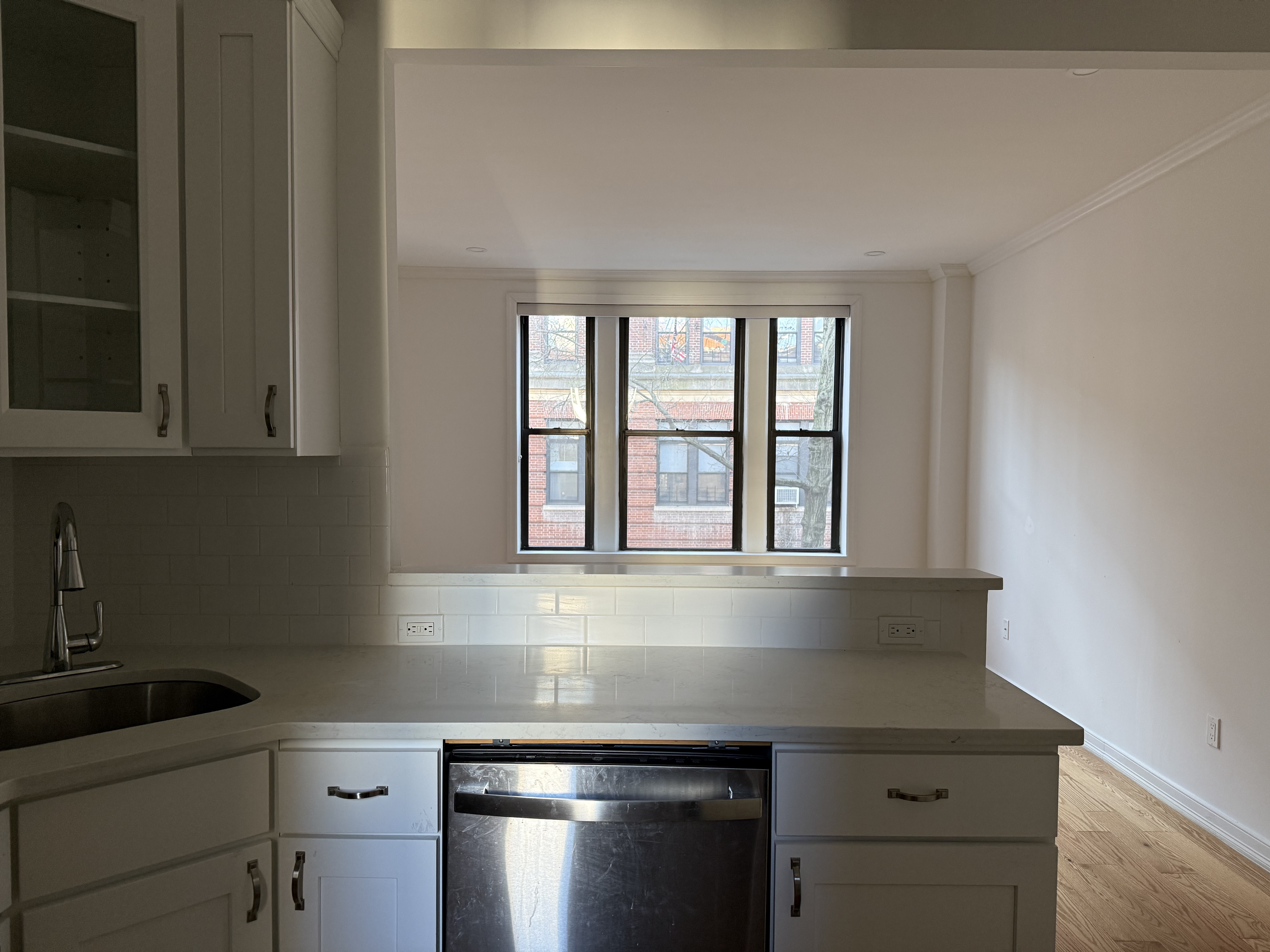 a kitchen with granite countertop cabinets stainless steel appliances and a sink
