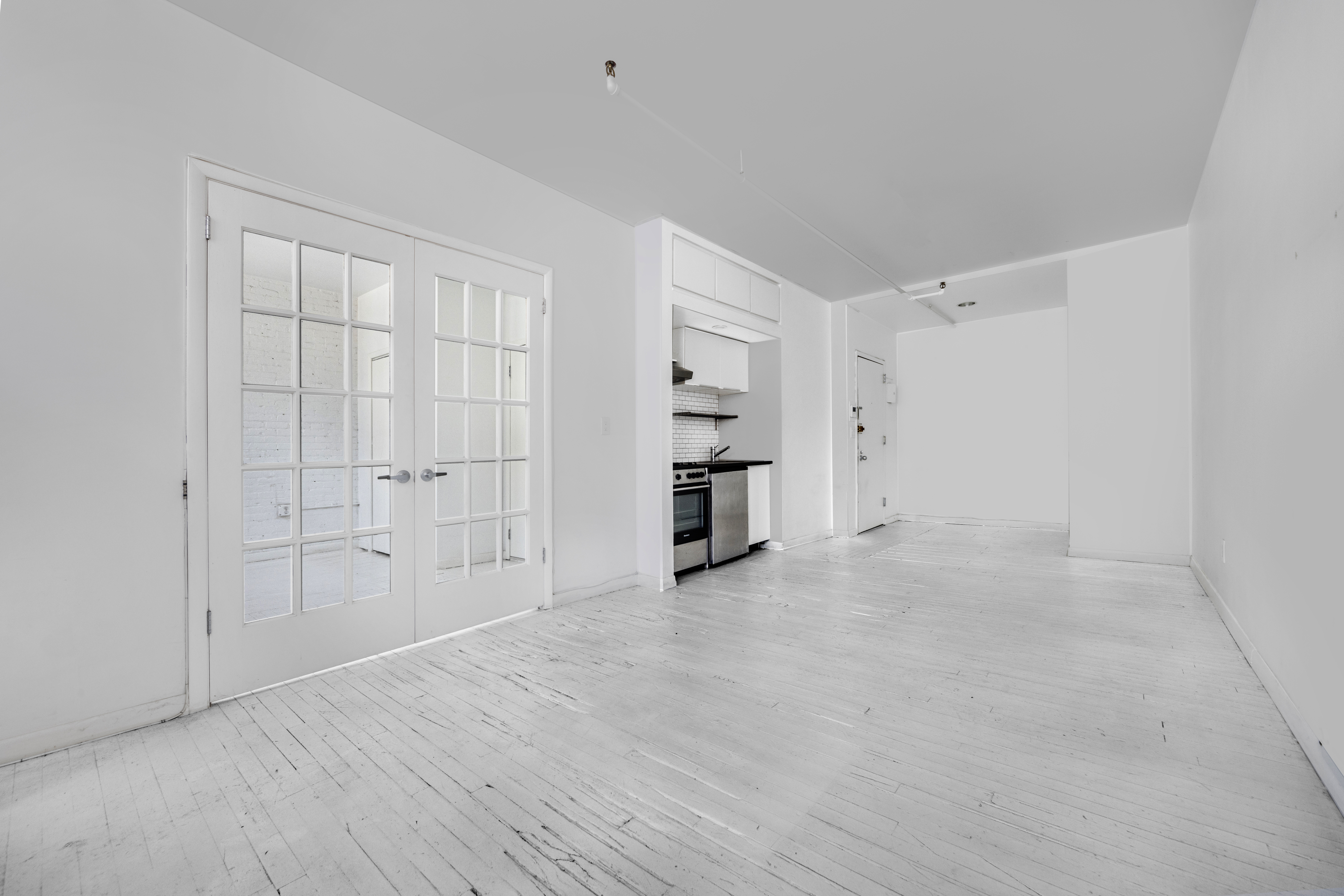 10 Leonard Street, Unit 6N Manhattan, NY 10013 - Photo 9 of 12 a view of empty room with wooden floor