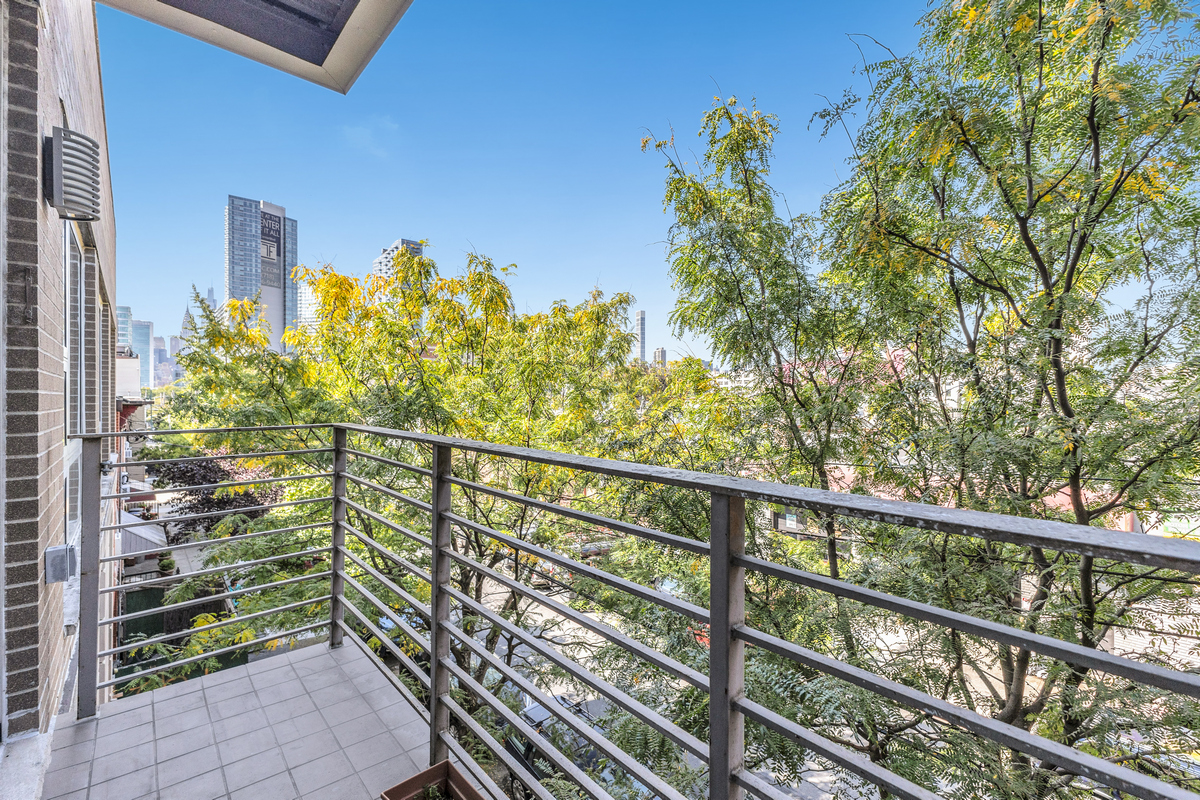 10-40 46th Road, Unit 3D Queens, NY 11101 - Photo 9 of 10 a view of a balcony with wooden fence