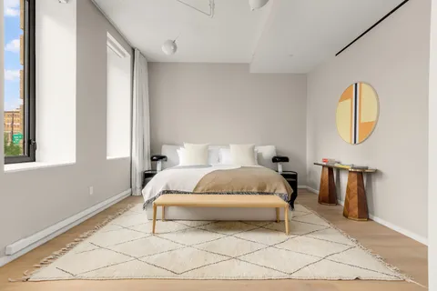 a bedroom with a bed lamp and a window