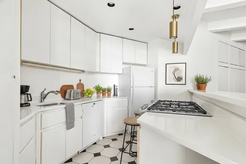 a kitchen with stainless steel appliances a refrigerator sink and cabinets