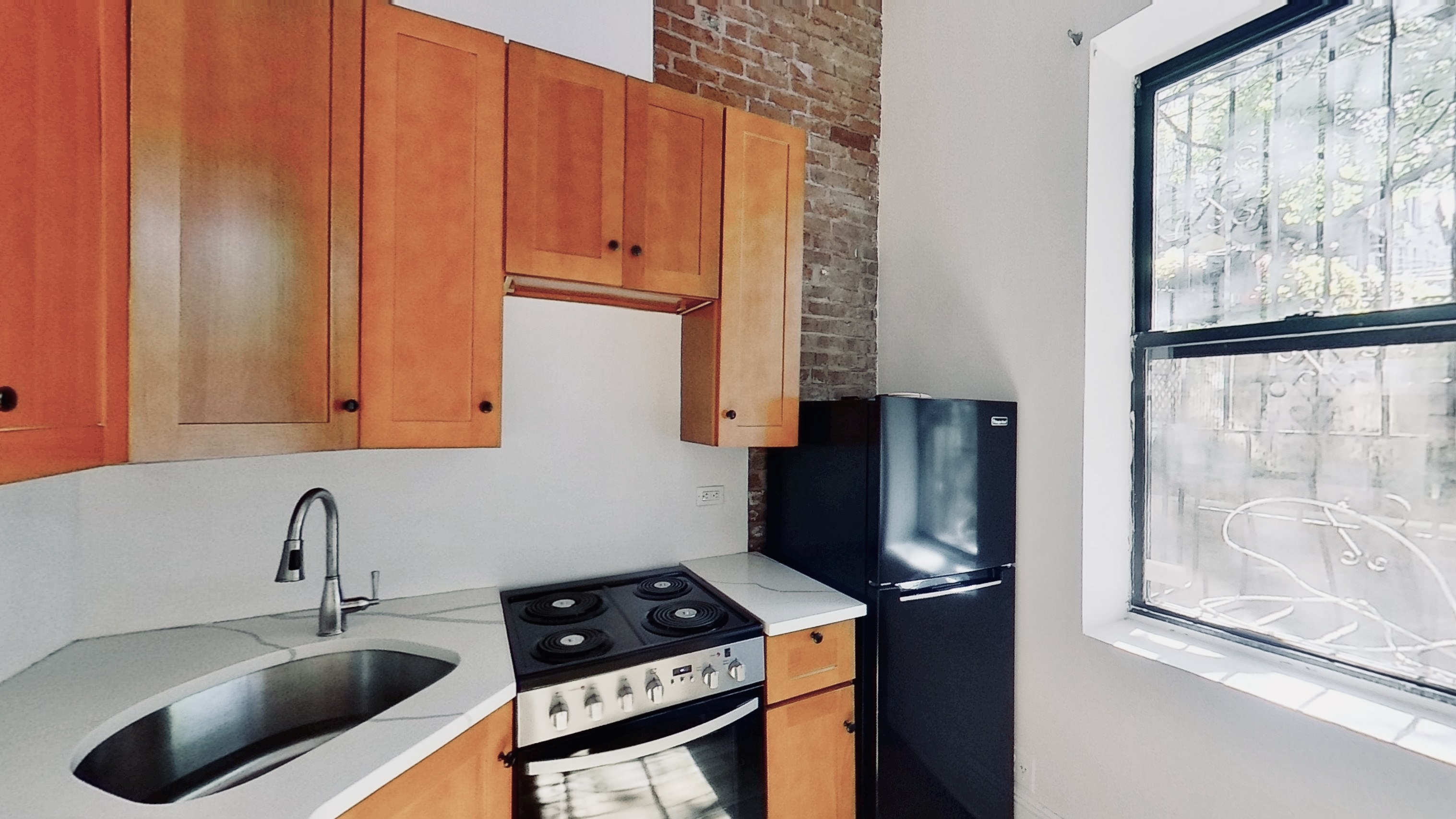 347 5th Avenue, Unit 1L Brooklyn, NY 11215 - Photo 6 of 10 a kitchen with stainless steel appliances granite countertop a sink stove and refrigerator