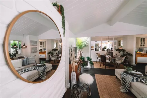 a view of a livingroom with furniture and floor to ceiling window