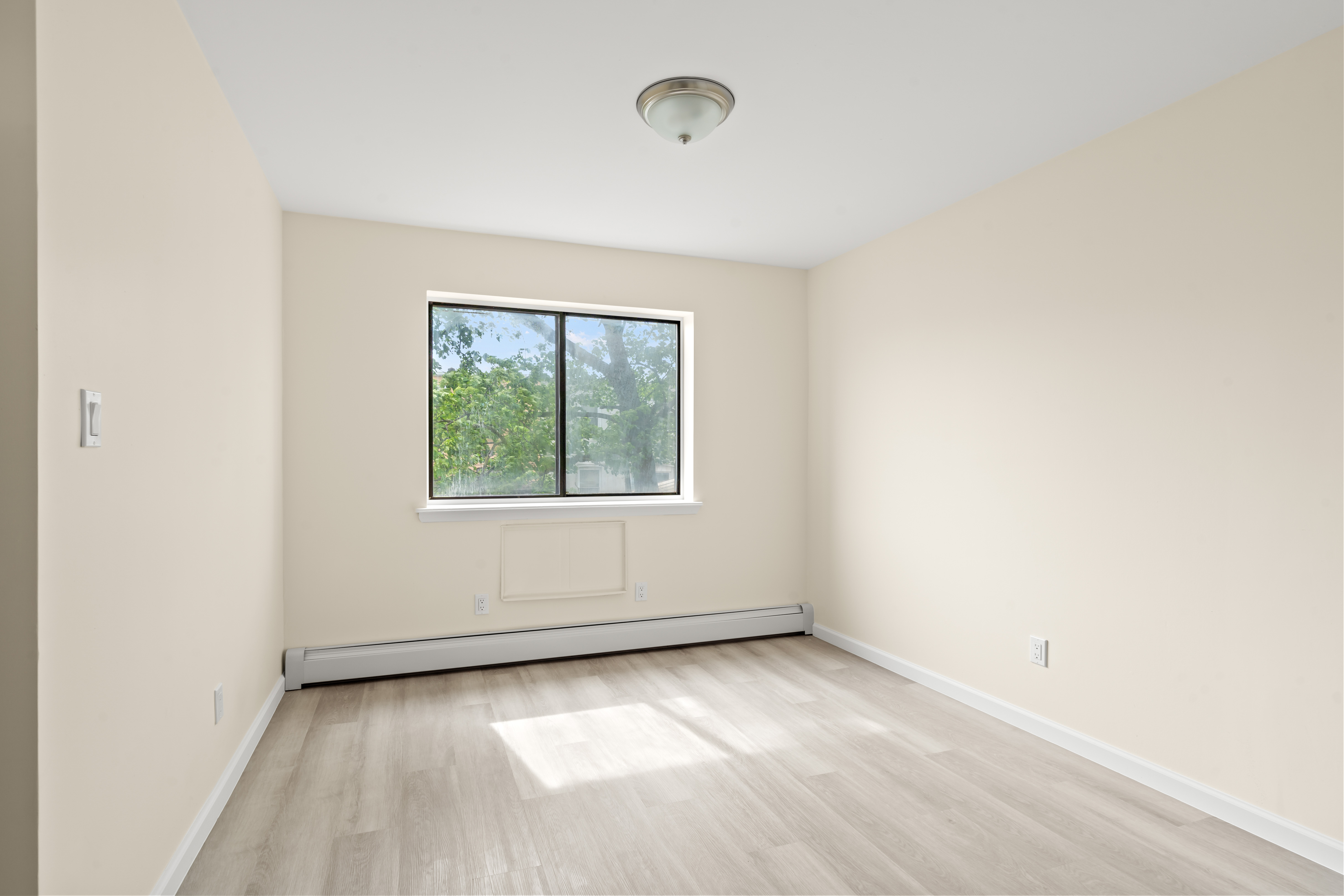 37-30 103rd Street, Unit 2E Queens, NY 11368 - Photo 4 of 8 an empty room with a window