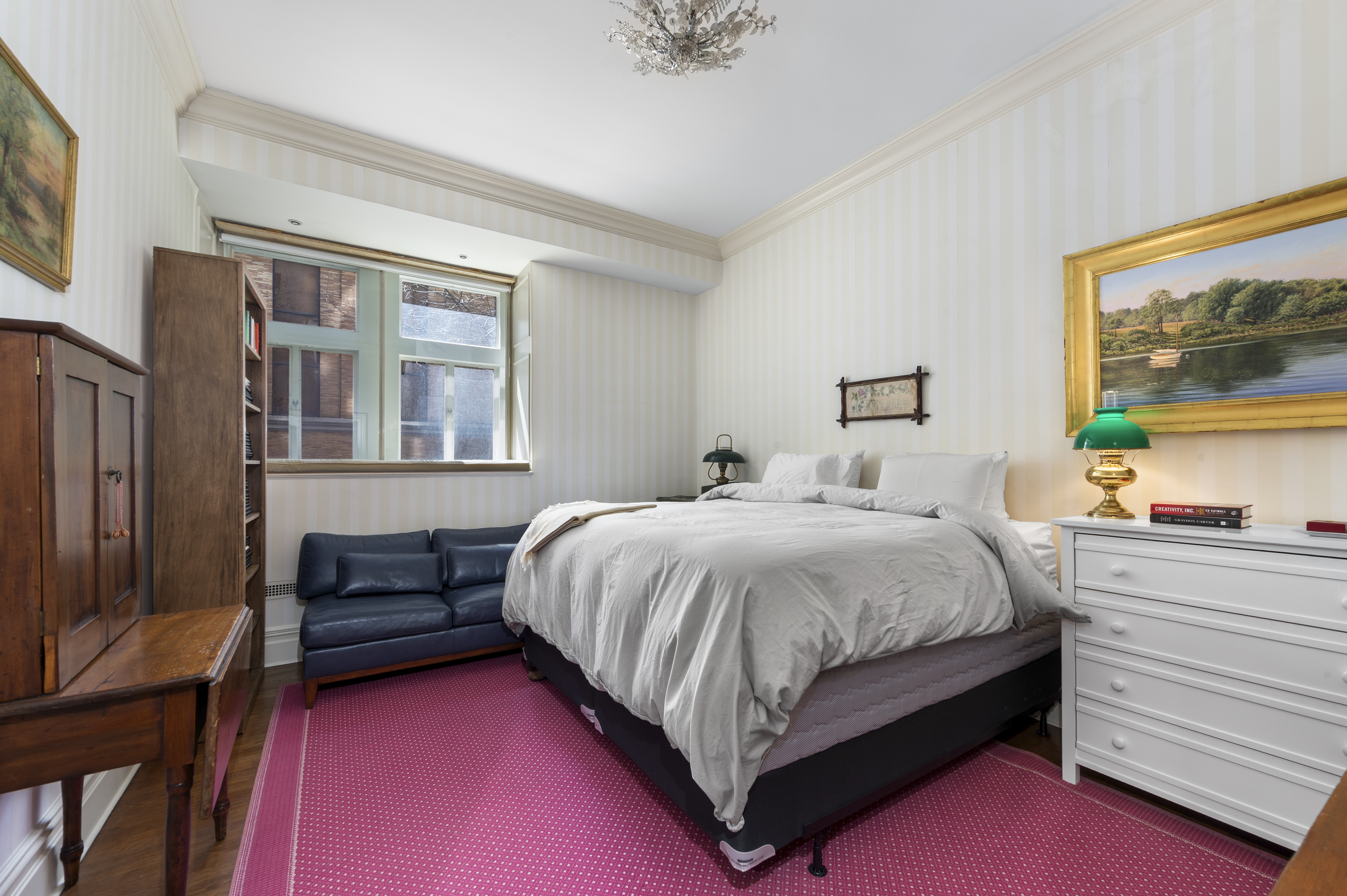 1 West 67th Street, Unit 2M Manhattan, NY 10023 - Photo 7 of 15 a bedroom with a bed and a window