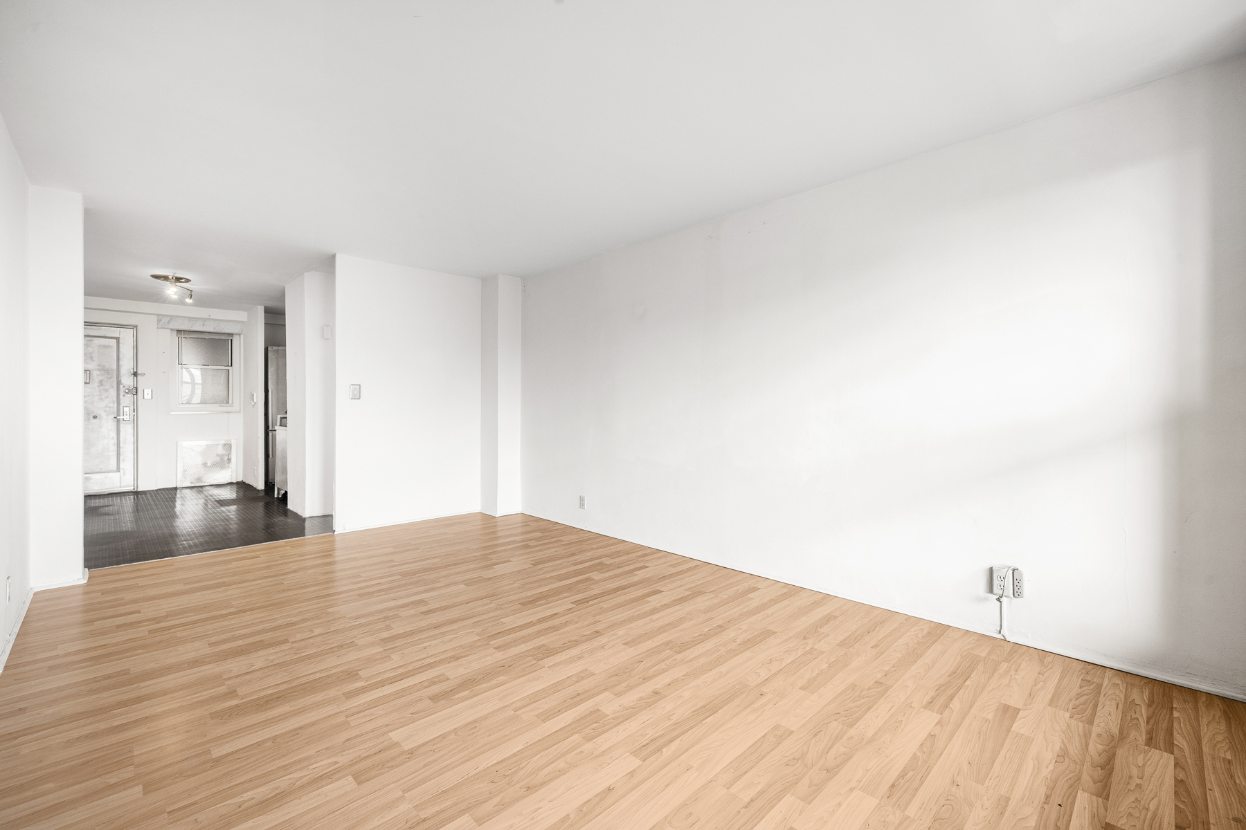 35-50 85th Street, Unit 9J Queens, NY 11372 - Photo 5 of 11 a view of empty room with wooden floor