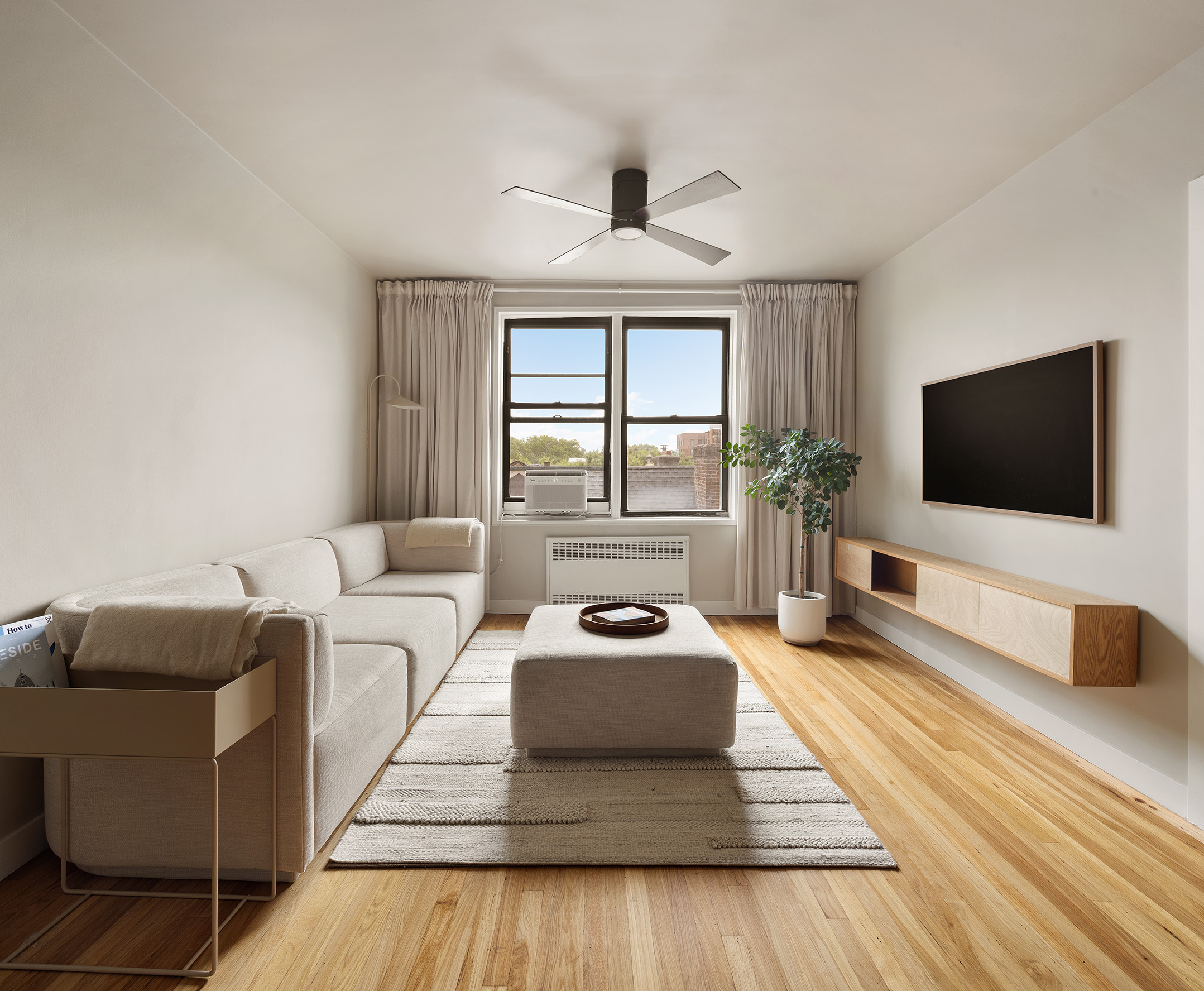 100 Ocean Parkway, Unit 4H Brooklyn, NY 11218 - Photo 1 of 11 a living room with furniture and a flat screen tv