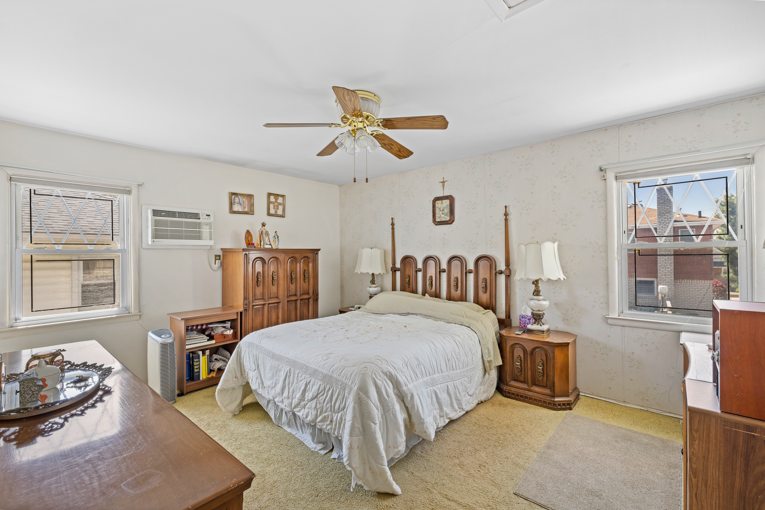 14-28 140th Street Queens, NY 11357 - Photo 7 of 14 a bedroom with a bed and wooden floor