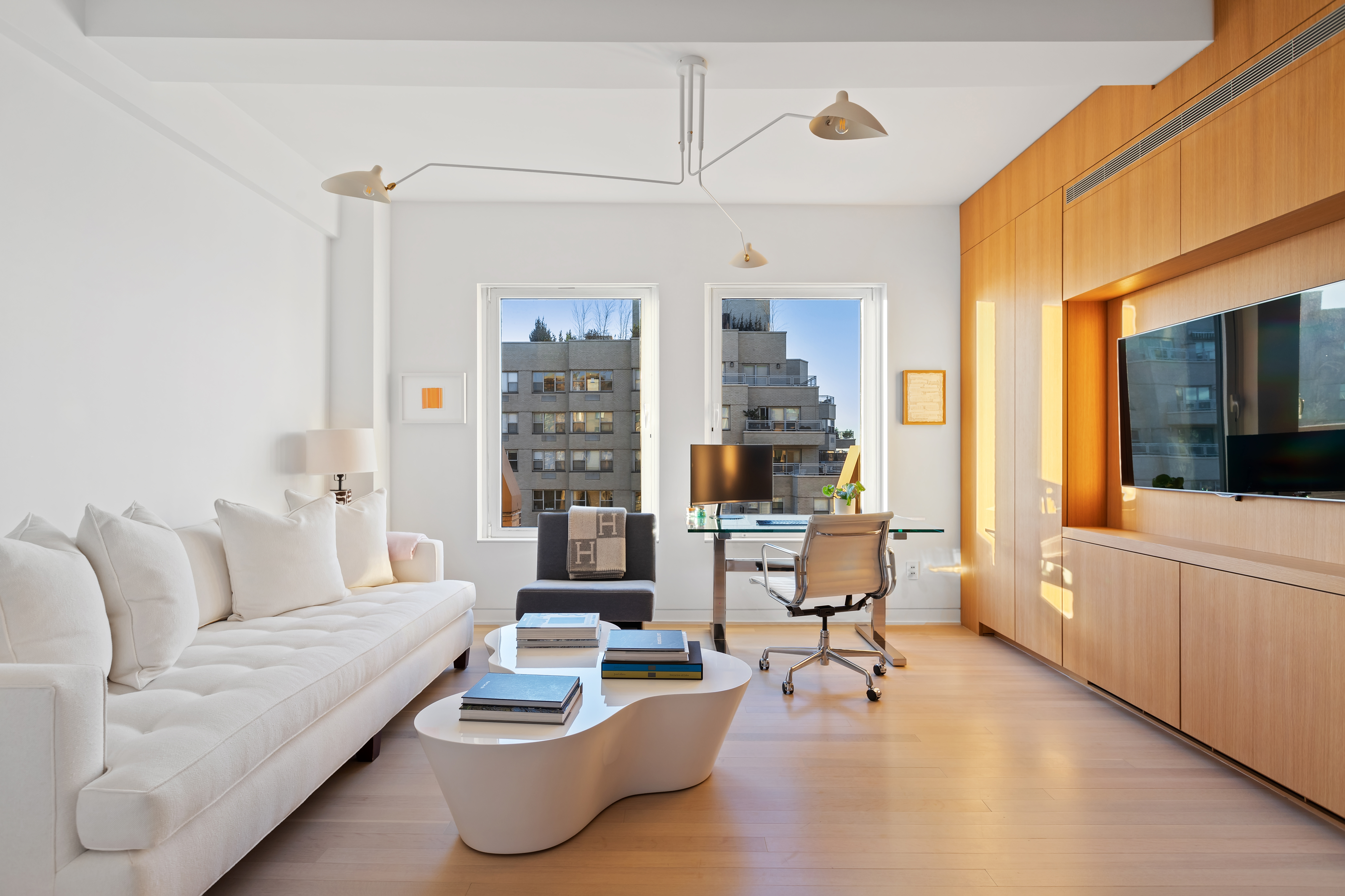 1 5th Avenue, Unit 16F Manhattan, NY 10003 - Photo 18 of 23 a living room with furniture and a flat screen tv