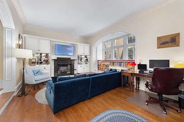 1 West 67th Street, Unit 2M Manhattan, NY 10023 - Photo 3 of 16 a view of a livingroom with furniture and a fireplace