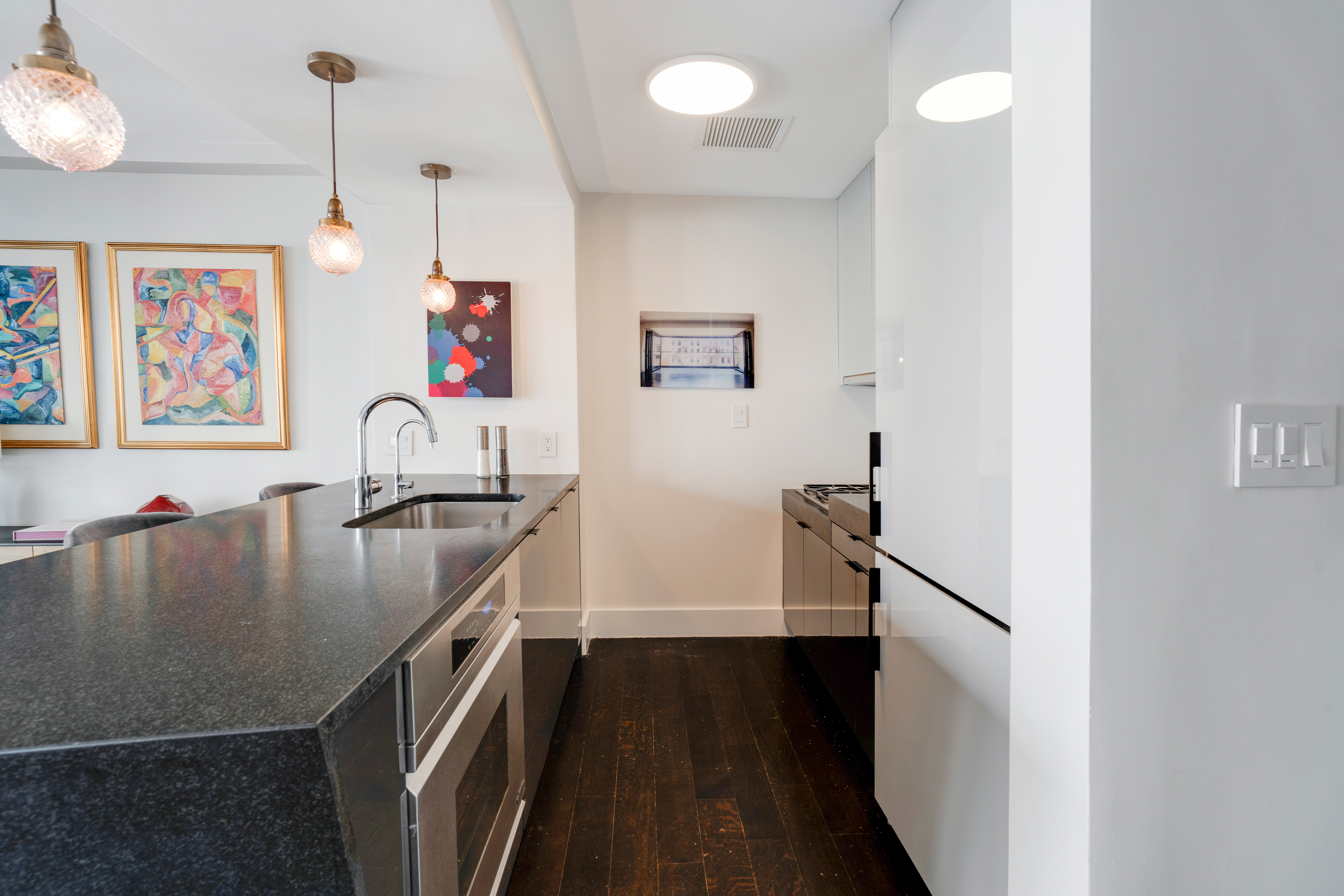 60 Orchard Street, Unit 4 Manhattan, NY 10002 - Photo 11 of 18 a view of kitchen island with furniture and wooden floor