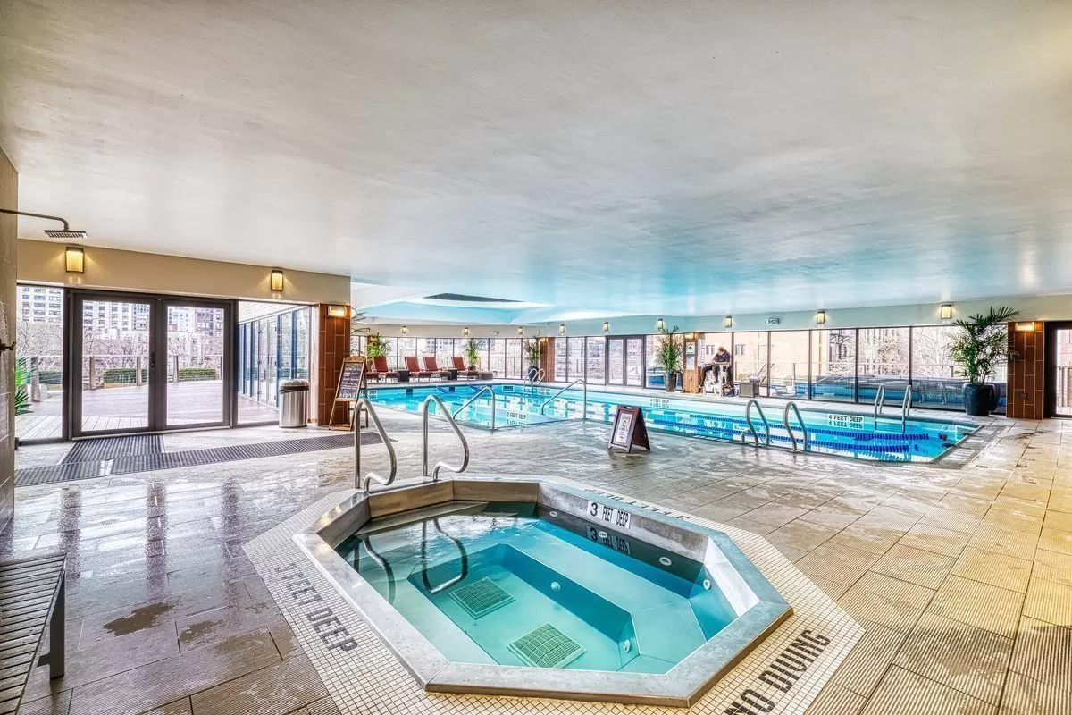 330 East 38th Street, Unit 26F Manhattan, NY 10016 - Photo 9 of 11 a swimming pool with outdoor seating and yard