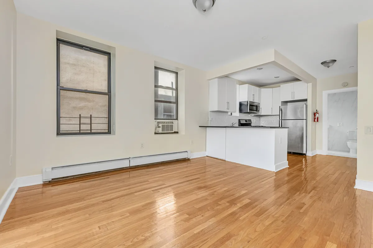 a view of a kitchen with microwave and windows