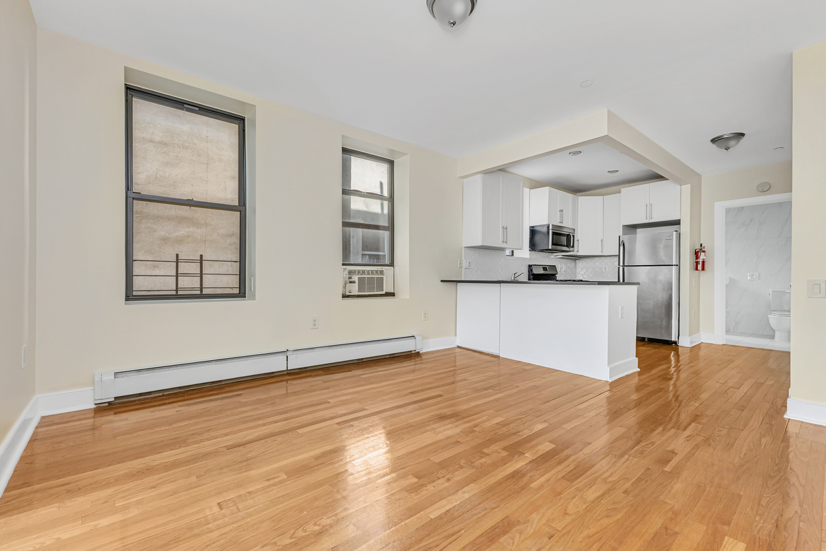 305 West 150th Street, Unit 606 Manhattan, NY 10039 - Photo 2 of 6 a view of a kitchen with microwave and windows