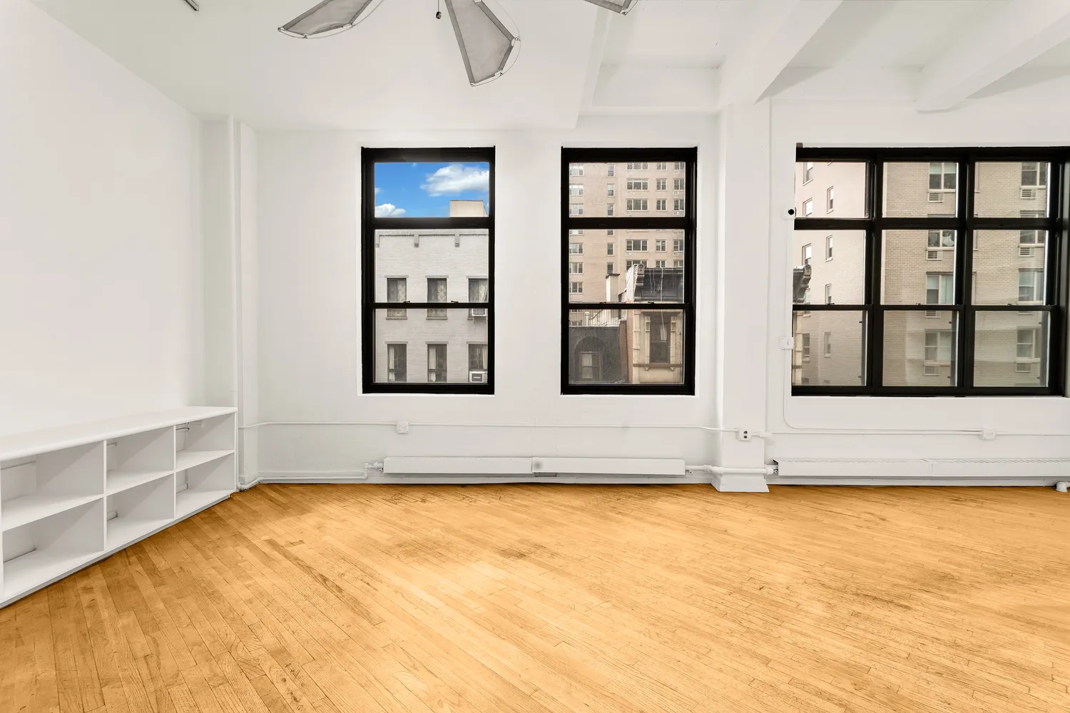 a view of wooden floor and windows in a room
